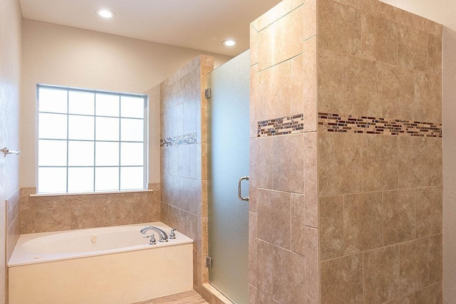 bathroom with shower with separate bathtub