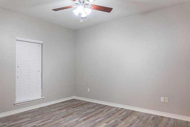 spare room featuring dark hardwood / wood-style floors and ceiling fan