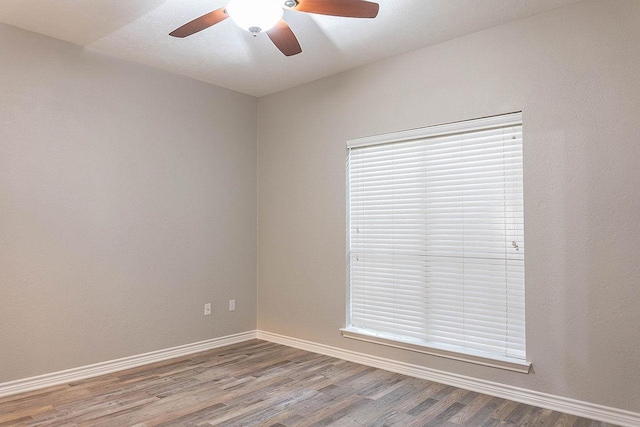 unfurnished room with hardwood / wood-style flooring, ceiling fan, and plenty of natural light