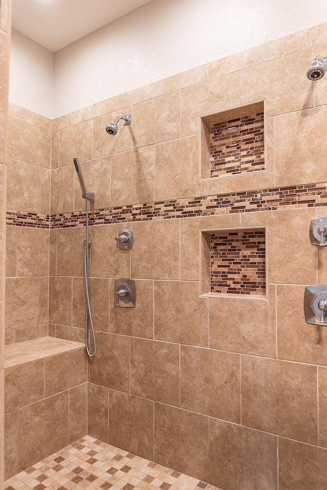 bathroom with a tile shower