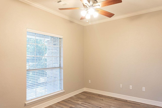 empty room featuring crown molding, ceiling fan, and wood-type flooring