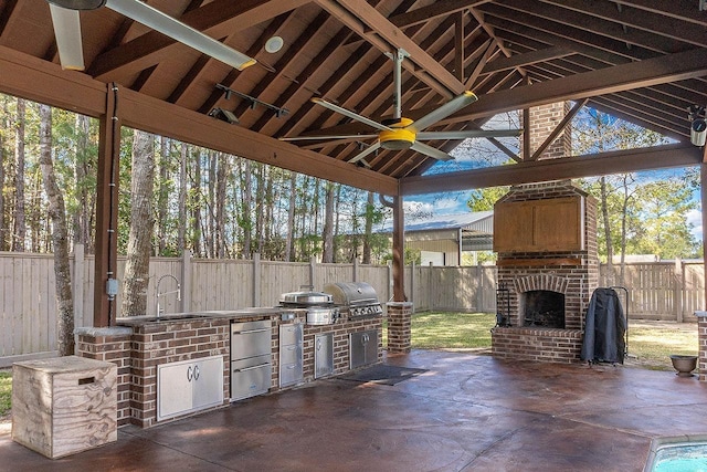 view of patio / terrace with area for grilling, an outdoor brick fireplace, ceiling fan, sink, and a gazebo