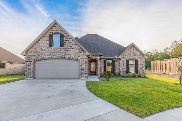 view of front of home with a front yard and a garage