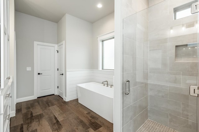 bathroom featuring hardwood / wood-style floors and separate shower and tub