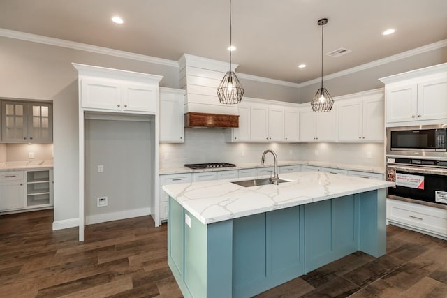 kitchen featuring white cabinetry, sink, an island with sink, and appliances with stainless steel finishes