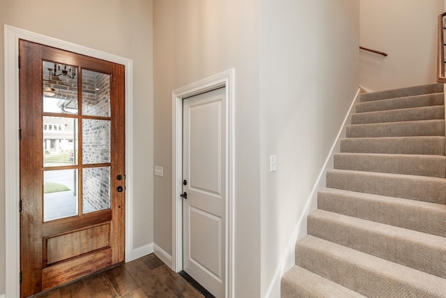 entryway with dark hardwood / wood-style flooring