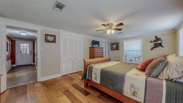 310 Junker Rd, Beaumont, TX 77707 - bedroom featuring ornamental molding, light wood-type flooring, baseboards, a closet, and ceiling fan
