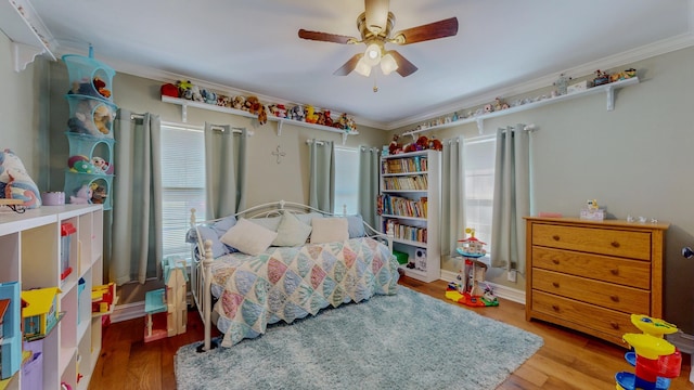 310 Junker Rd, Beaumont, TX 77707 - bedroom with multiple windows, wood finished floors, crown molding, and a ceiling fan