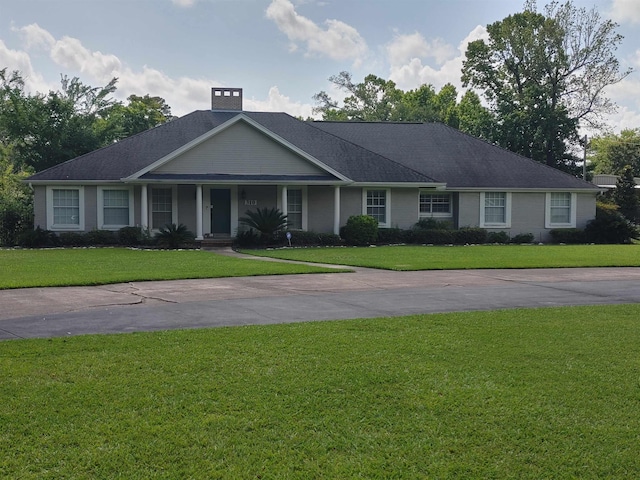 310 Junker Rd, Beaumont, TX 77707 - view of front of property featuring a front lawn, a porch, and concrete driveway