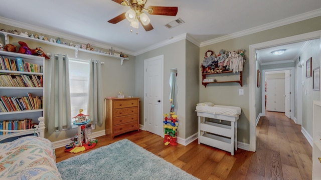 310 Junker Rd, Beaumont, TX 77707 - bedroom with wood finished floors, ornamental molding, baseboards, and a ceiling fan