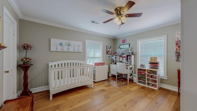310 Junker Rd, Beaumont, TX 77707 - bedroom featuring light wood-style floors, multiple windows, ornamental molding, baseboards, and ceiling fan