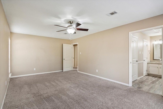 carpeted empty room with ceiling fan