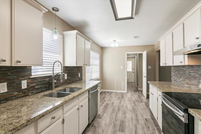 kitchen featuring white cabinets, pendant lighting, stainless steel appliances, and sink