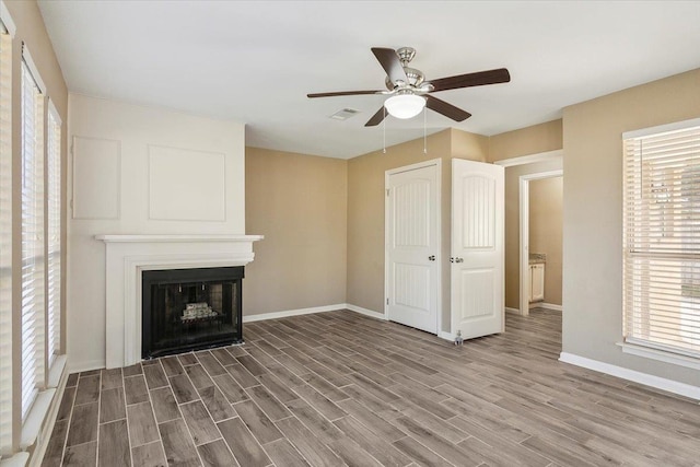 unfurnished living room with ceiling fan, hardwood / wood-style floors, and a healthy amount of sunlight