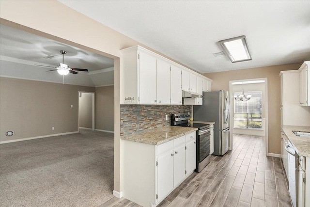 kitchen featuring light stone counters, white cabinets, and stainless steel appliances