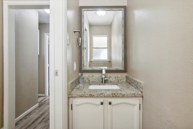 bathroom featuring hardwood / wood-style floors and vanity