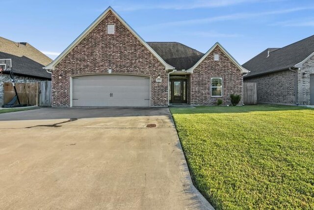 view of front of house featuring a front yard and a garage