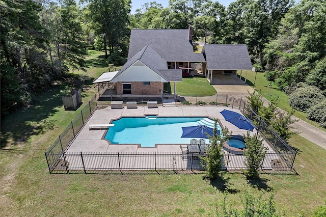 view of swimming pool with a diving board, a yard, and a patio