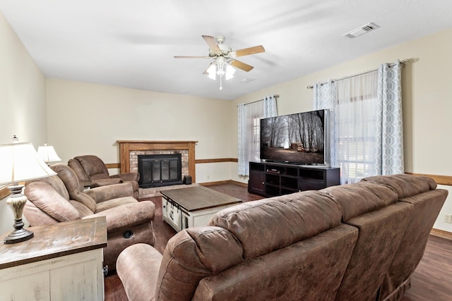 living room with ceiling fan and dark wood-type flooring