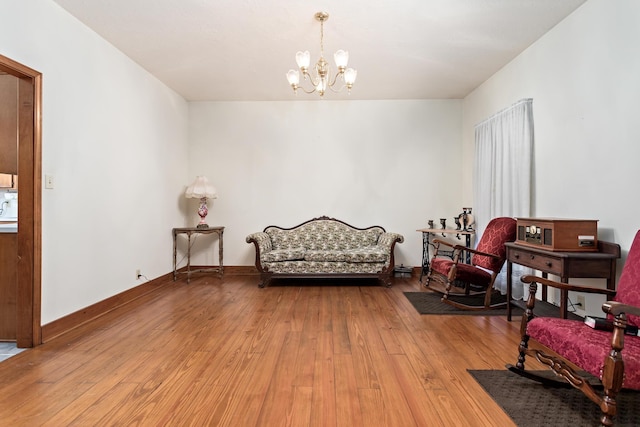 sitting room with light hardwood / wood-style flooring and a chandelier