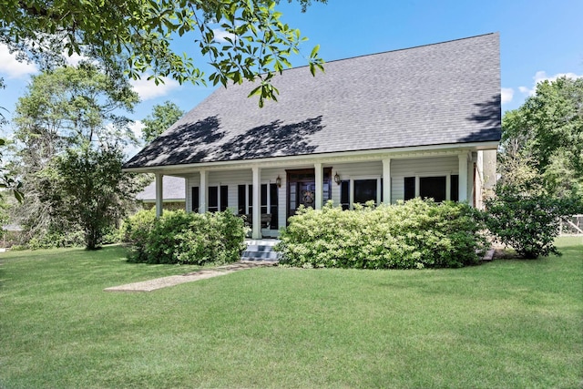 back of property featuring a lawn and covered porch