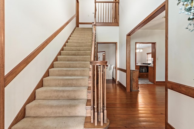 stairway with hardwood / wood-style floors