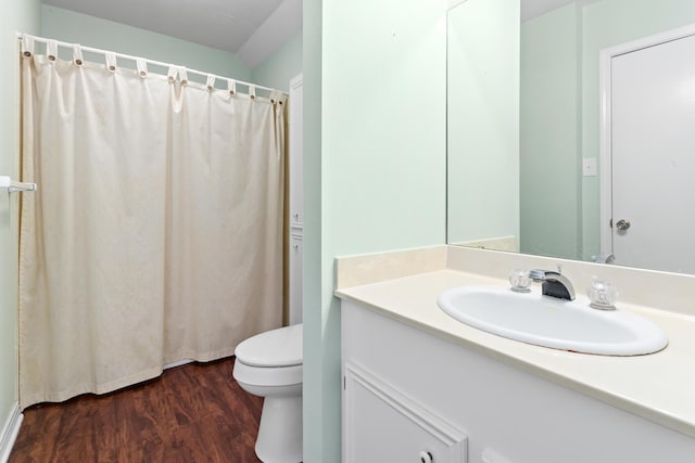 bathroom with vanity, wood-type flooring, and toilet