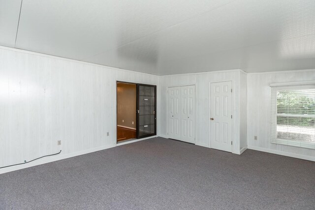 10754 Bonwell Loop, Kountze, TX 77625 - unfurnished bedroom featuring dark colored carpet and multiple closets