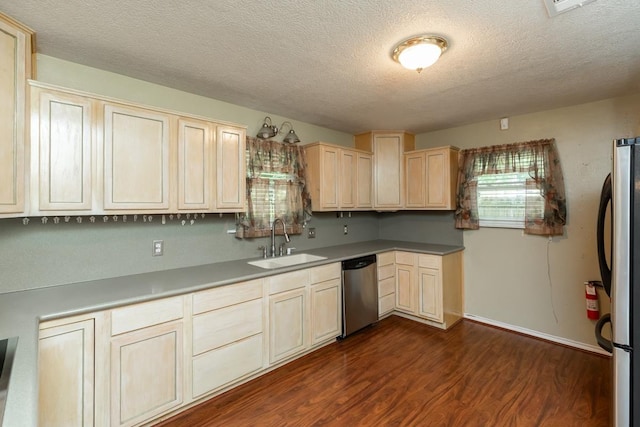 10754 Bonwell Loop, Kountze, TX 77625 - kitchen with appliances with stainless steel finishes, light brown cabinets, dark wood finished floors, and a textured ceiling