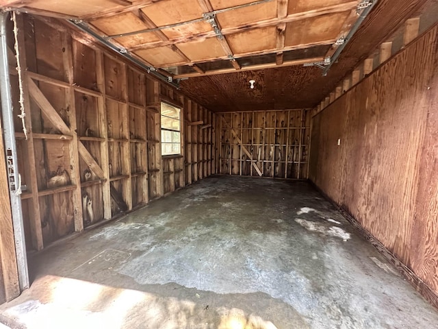 miscellaneous room with concrete flooring and a garage