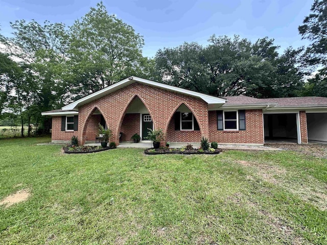 ranch-style house with an attached carport, driveway, a front lawn, and brick siding