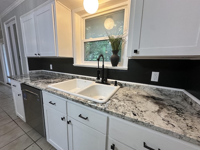 kitchen with light stone countertops, dishwasher, white cabinets, a sink, and light tile patterned floors