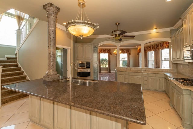 kitchen featuring a peninsula, light tile patterned flooring, arched walkways, ornamental molding, and appliances with stainless steel finishes