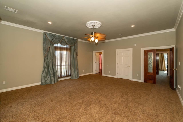 unfurnished room with a ceiling fan, baseboards, visible vents, carpet floors, and ornamental molding