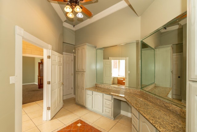 bathroom featuring a ceiling fan, a high ceiling, crown molding, and tile patterned flooring