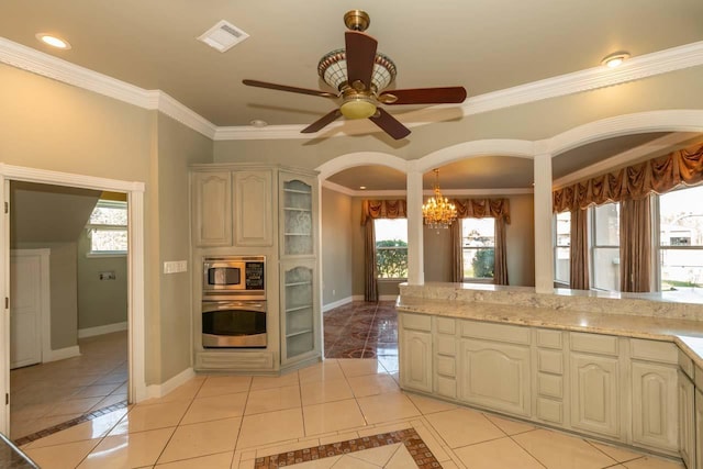 kitchen featuring light tile patterned floors, visible vents, baseboards, stainless steel appliances, and crown molding