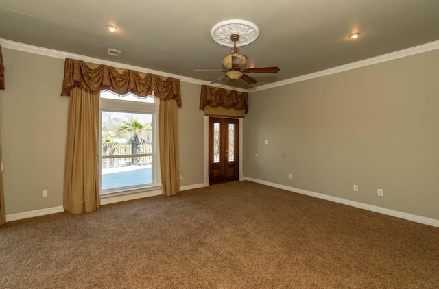 unfurnished room featuring crown molding, baseboards, and carpet floors