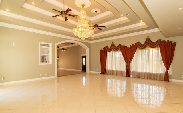 spare room featuring baseboards, a tray ceiling, light tile patterned floors, ceiling fan with notable chandelier, and arched walkways