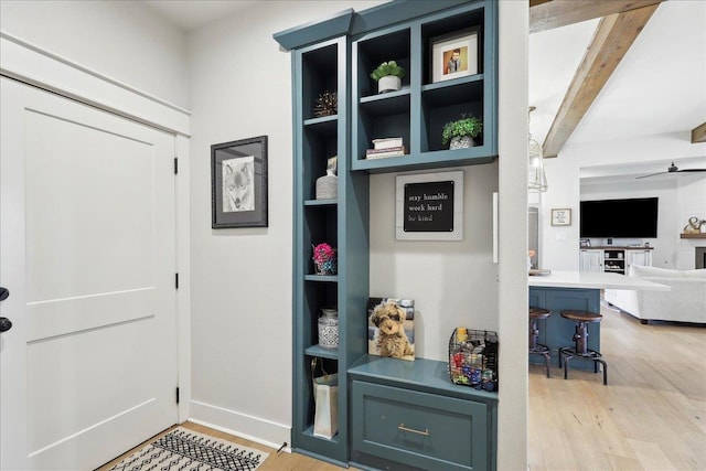 mudroom featuring beam ceiling, a ceiling fan, light wood-type flooring, and baseboards