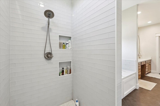 full bathroom featuring recessed lighting, tiled shower, a garden tub, and vanity