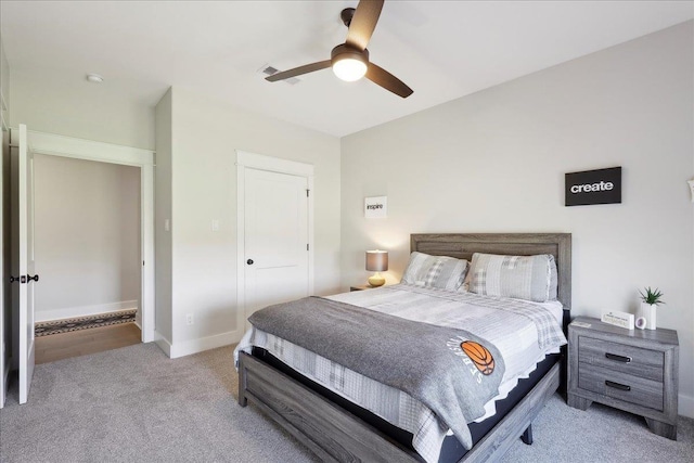 bedroom with visible vents, carpet floors, baseboards, and ceiling fan