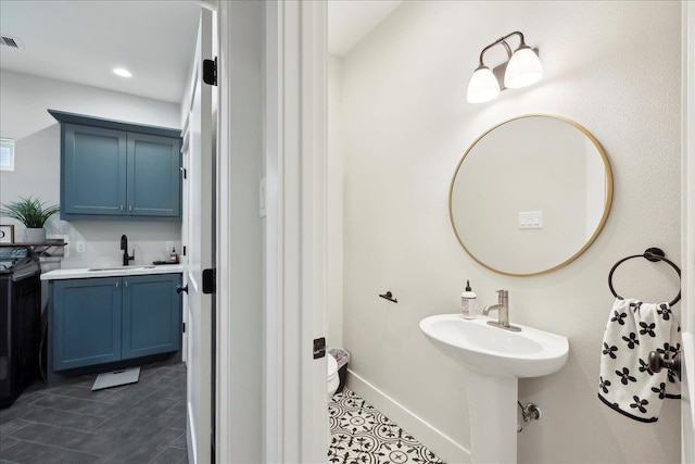 bathroom featuring visible vents, baseboards, recessed lighting, a sink, and tile patterned flooring