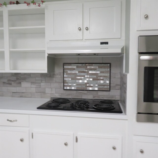 kitchen with black electric cooktop, white cabinets, stainless steel oven, and open shelves