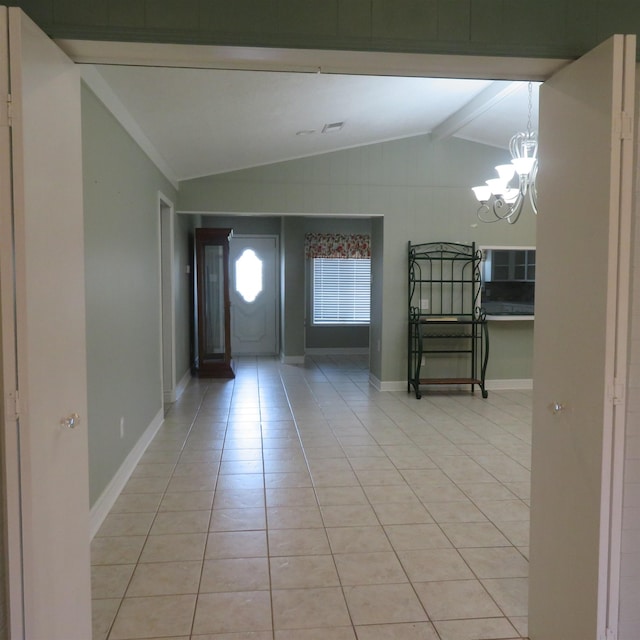 foyer entrance with light tile patterned floors, lofted ceiling with beams, baseboards, and an inviting chandelier