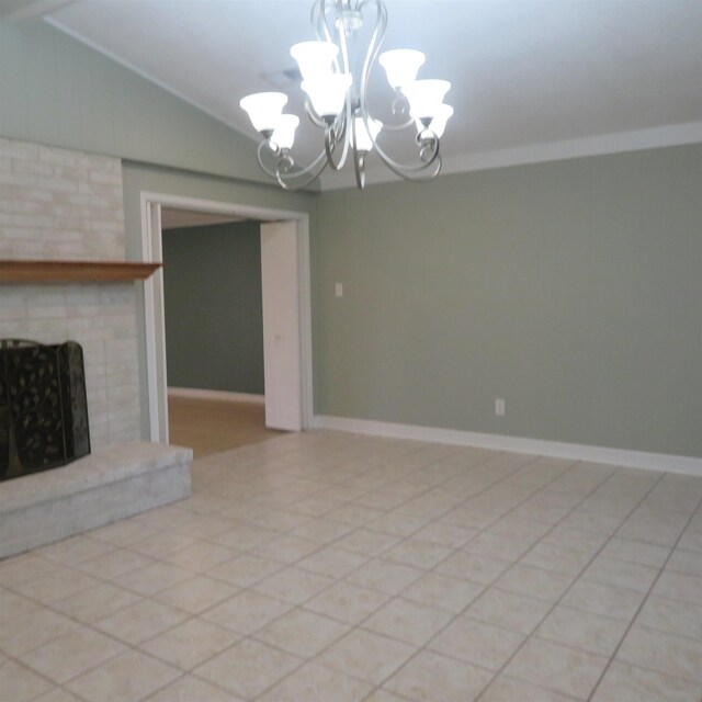 unfurnished living room with baseboards, vaulted ceiling, crown molding, a fireplace, and a chandelier