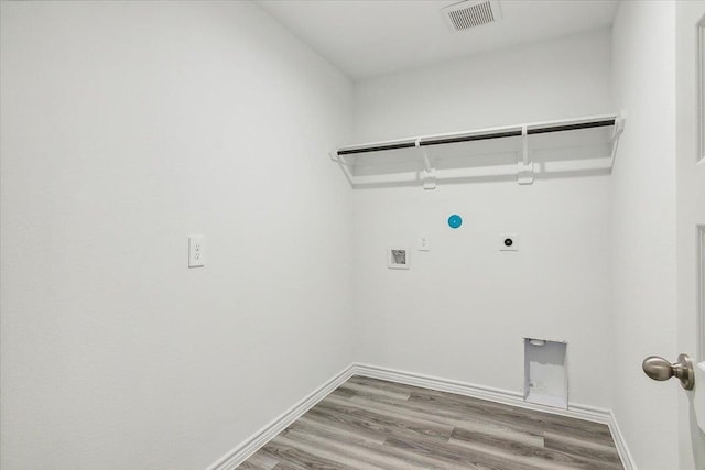 clothes washing area featuring electric dryer hookup, hookup for a gas dryer, washer hookup, and wood-type flooring