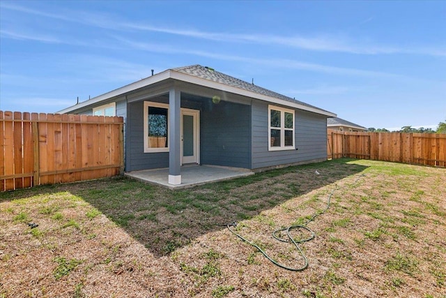 rear view of property with a patio area and a lawn