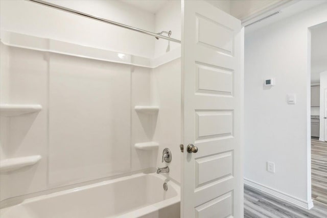 bathroom featuring  shower combination and wood-type flooring