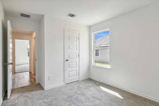 unfurnished bedroom featuring light colored carpet