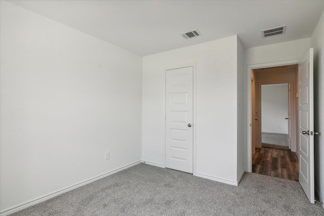 unfurnished bedroom with carpet and a closet